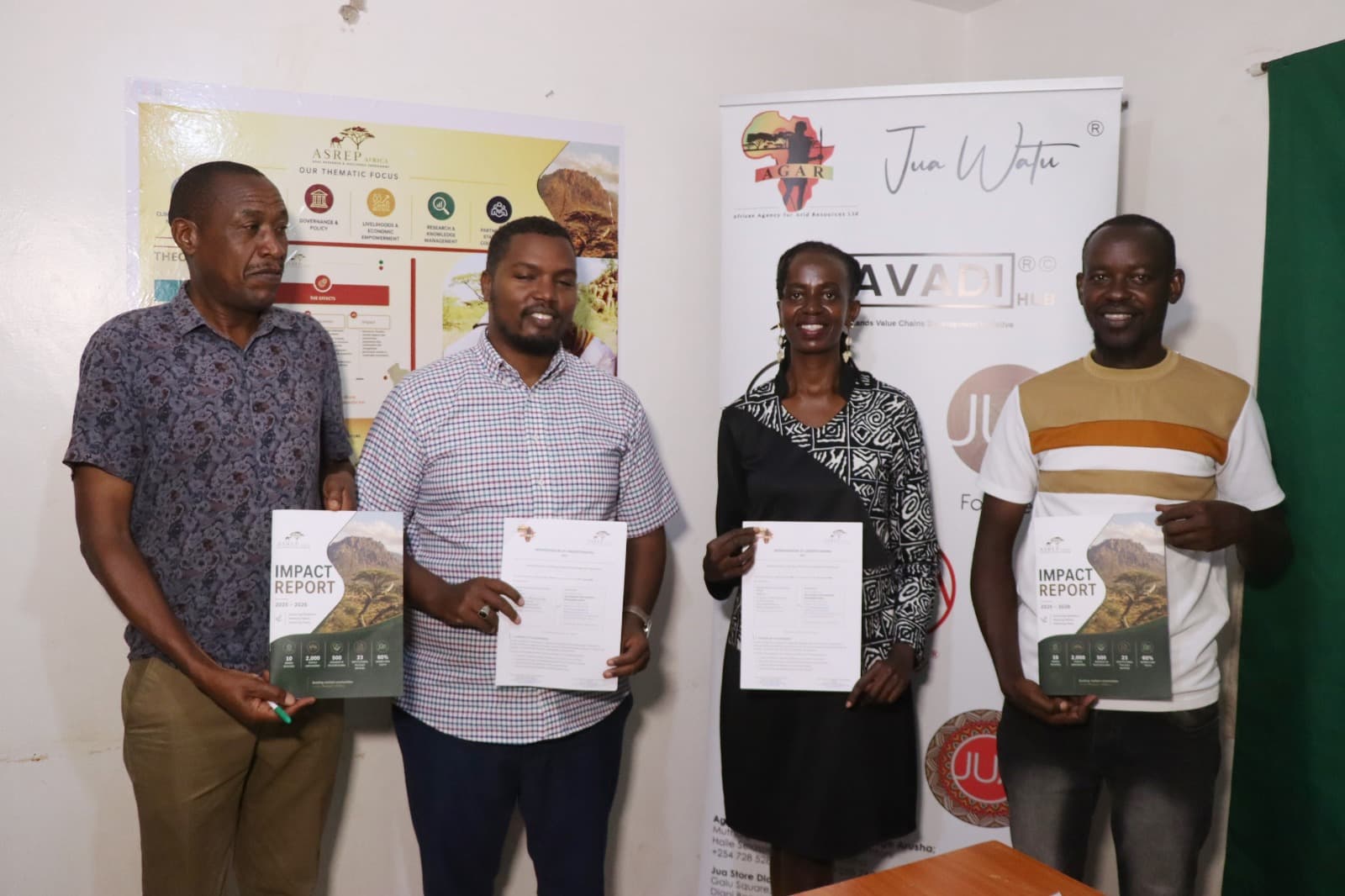 Four ASREP Africa and AGAR partners posing with the signed MOU and copies of the ASREP 2025–2026 Impact Report
