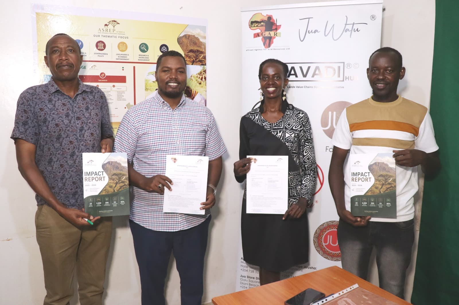 Representatives from ASREP Africa and African Agency for Arid Resources Limited (AGAR) holding the ASREP Impact Report after signing a strategic MOU Framework Agreement